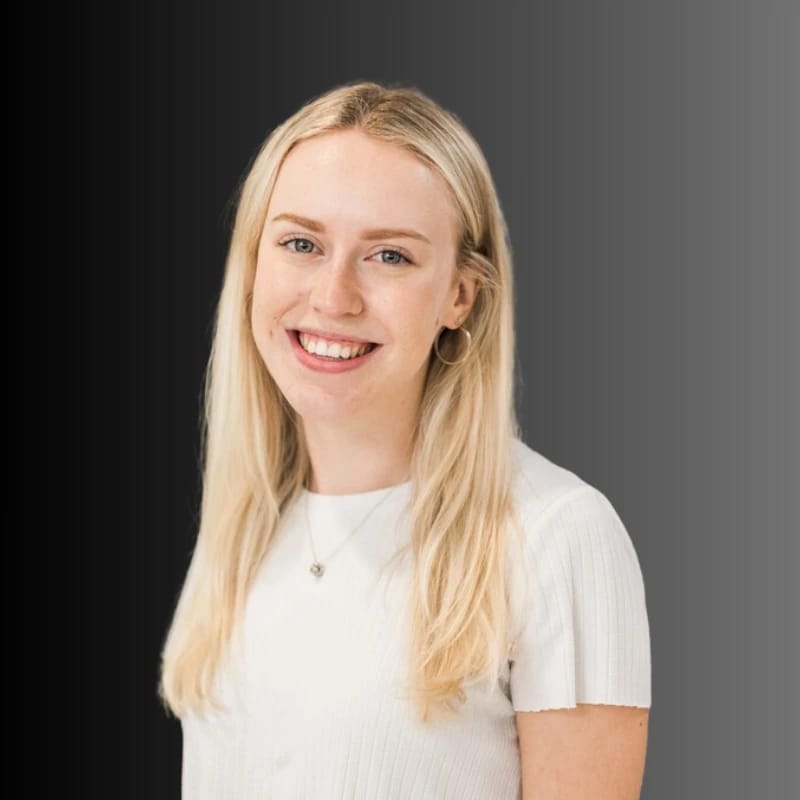 Smiling person with long blonde hair against a gradient background.